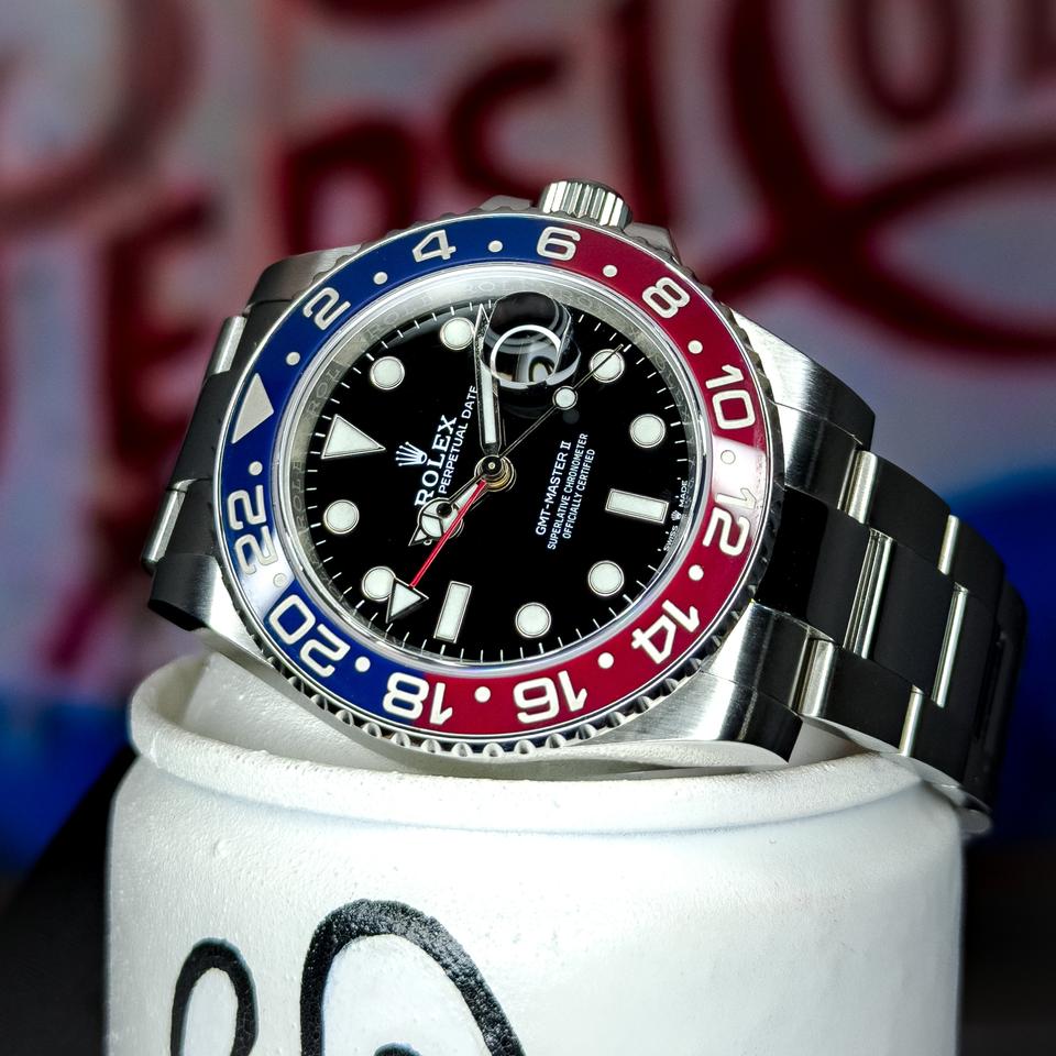 Rolex GMT-Master II 'Batman' on a Jubilee bracelet, resting on cream leather